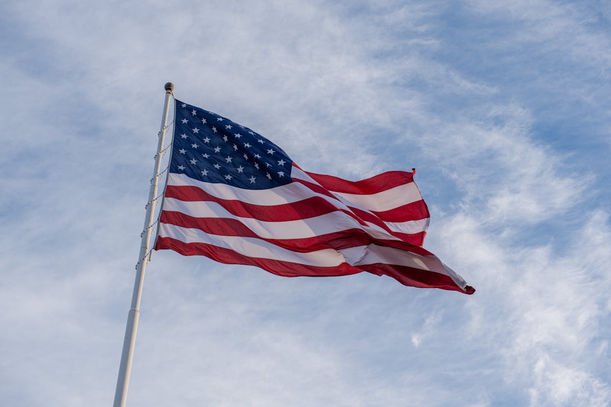 American flag waving against a blue sky
